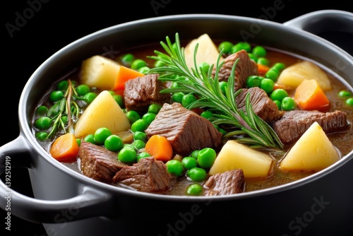A large pot of stew simmering with herbs and chunks of vegetables