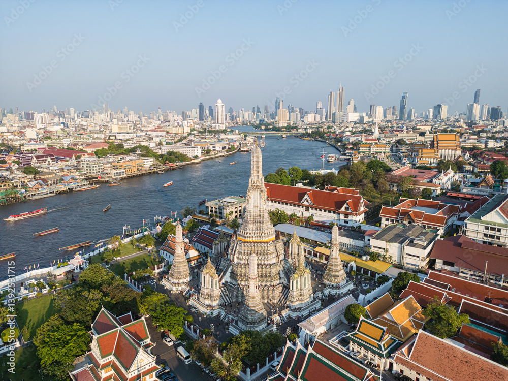 Aerial view pagoda buddha Temple of dawn Wat Arun river background sunset light with modern downtown city background