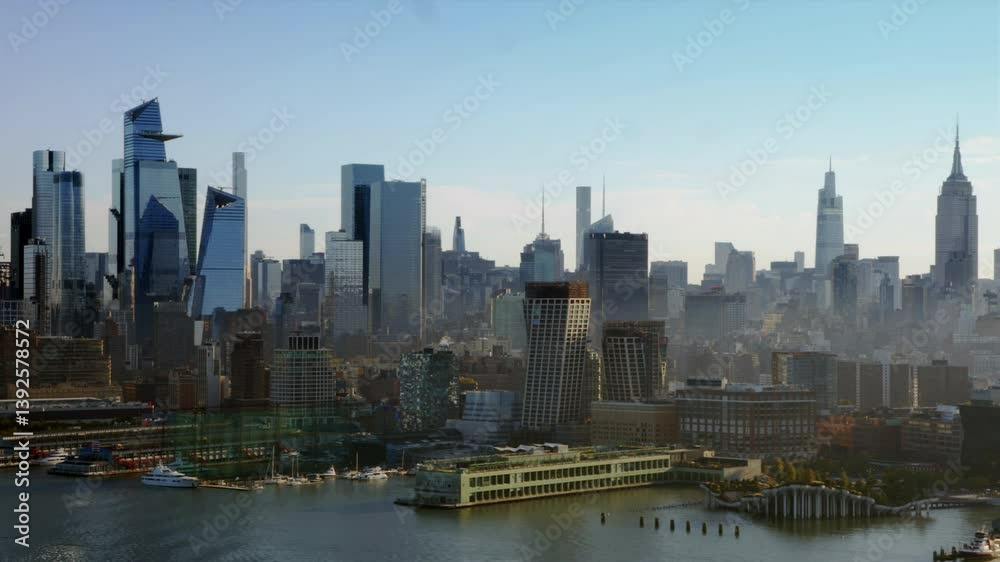 Breathtaking Aerial Overlook Of New York Urban Landscape, Featuring Gleaming Skyscrapers And A Meandering River Under A Vivid Sunset. Midtown Manhattan with Piers and Parks. Hudson Yards Neighborhood. Breathtaking Aerial Overlook Of New York Urban Landscape, Featuring Gleaming Skyscrapers And A Meandering River Under A Vivid Sunset. Midtown Manhattan with Piers and Parks. Hudson Yards Neighborhood.