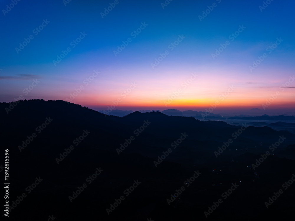 Beautiful sunset or sunrise sky nature landscape in Thailand,Amazing landscape colorful clouds over mountains in summer season background,Wide angle view drone shot