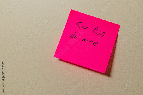 Motivational note on a wall encourages taking action and overcoming fear