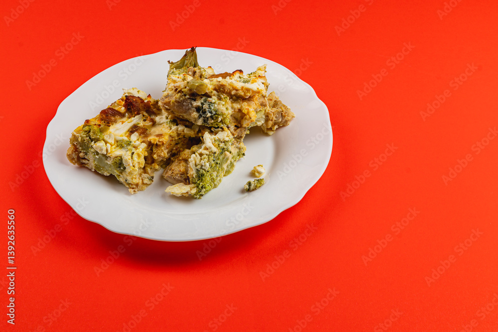Savory casserole with egg, broccoli, and chicken fillet on a bright plate Savory casserole with egg, broccoli, and chicken fillet on a bright plate