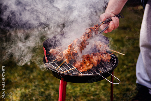 Grilling Meat Skewers Over Hot Charcoal at Outdoor BBQ