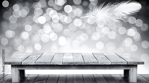 A white feather above a wooden table with blurred bokeh lights
