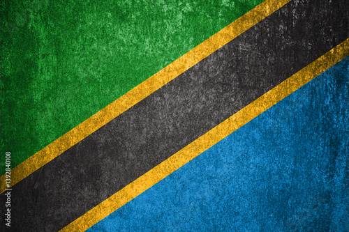 Tanzania State Flag. Dirty Tanzania flag on metal surface.