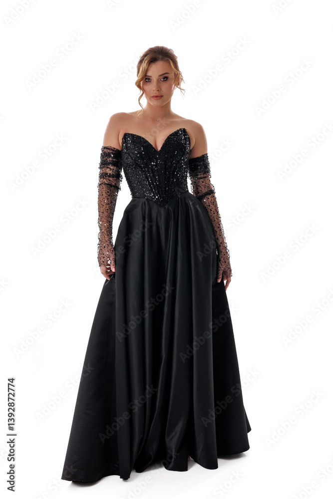 Fashion model showcases elegant black evening gown with sequins at a studio setting during a photoshoot Fashion model showcases elegant black evening gown with sequins at a studio setting during a photoshoot