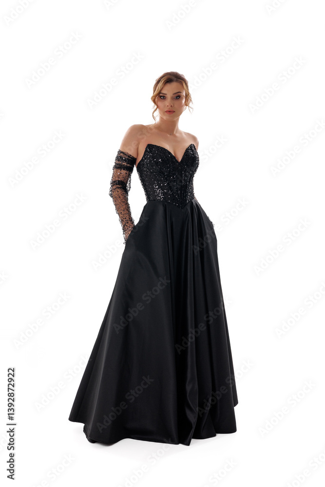 Elegant black evening gown with intricate details showcased in a studio setting Elegant black evening gown with intricate details showcased in a studio setting