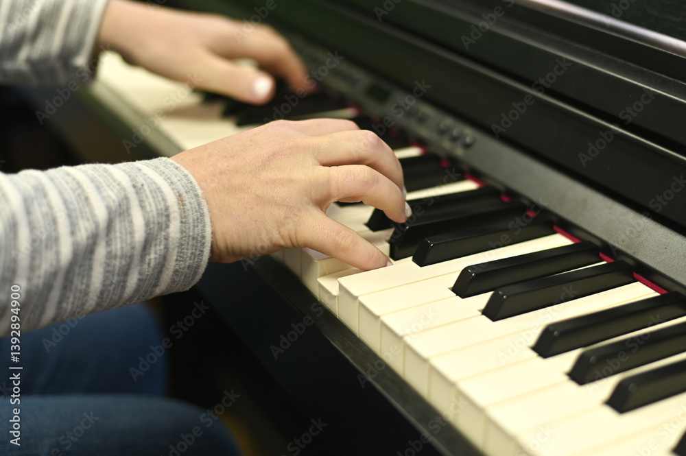Fototapeta premium Woman playing modern digital piano, focusing on melody creation and performance