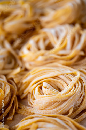 Wallpaper Mural Freshly made, uncooked pasta nests are closely arranged, showcasing their texture and golden color. The image highlights the intricate details and craftsmanship of homemade pasta, making it appealing  Torontodigital.ca