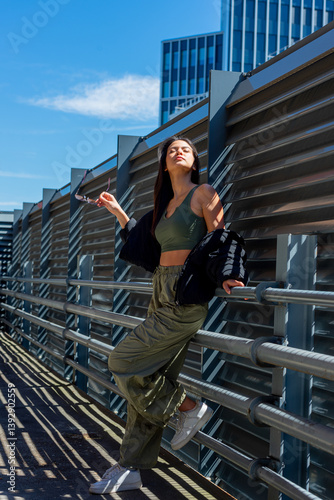 Cool Gen Z woman enjoying spring midday sunlight in a parking garage in Stuttgart, Germany