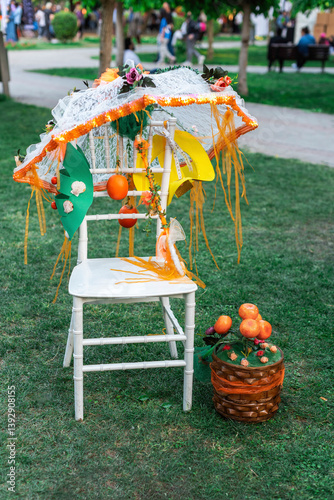Fancy umbrella  and chairs in a garden on the traditional orange blossom festival, close up