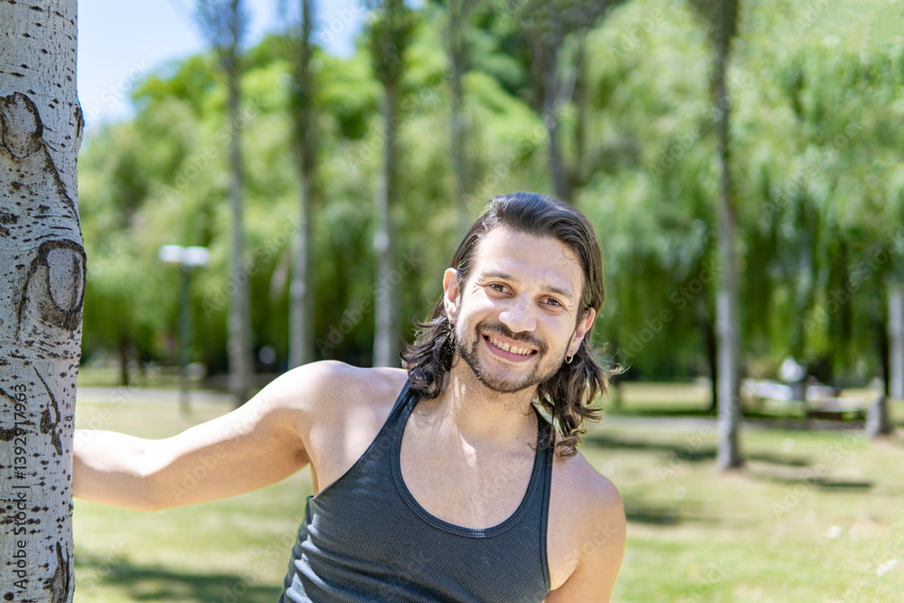 Latin man looks at the camera happily after exercising Latin man looks at the camera happily after exercising
