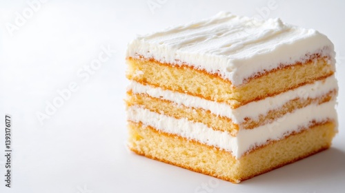 A square slice of layered cake, topped with a generous amount of white frosting