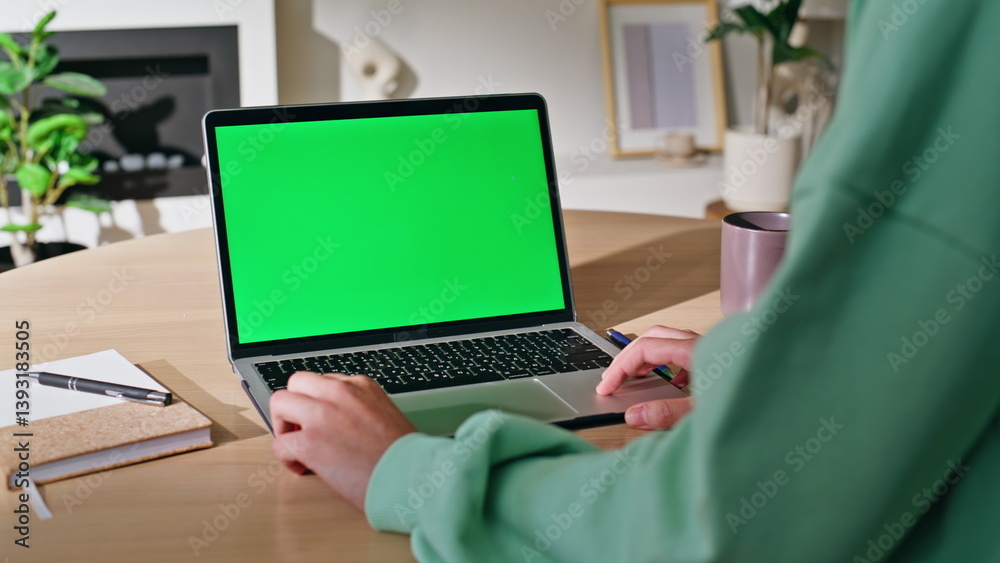 Freelancer working green screen laptop at home workplace closeup. Unknown woman