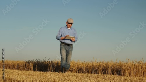 Wallpaper Mural man wearing blue shirt jeans standing field wheat. He looking tablet hand, farmer using tablet wheat field, Modern agricultural business strategies, Digital farming solutions wheat cultivation Torontodigital.ca