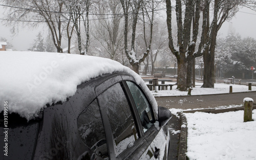 Car parked in a snow-covered village