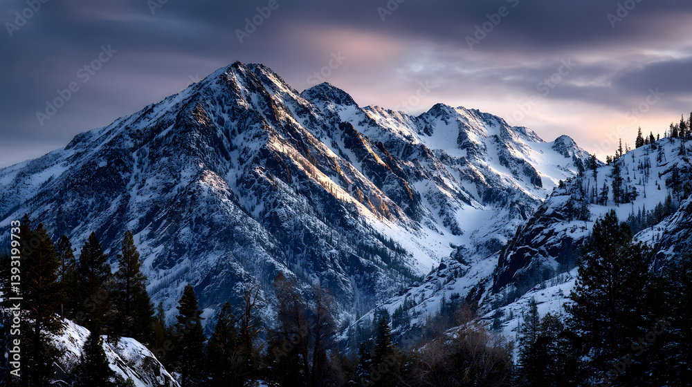 Obraz premium Snow-draped mountain range basking in the last light of day.