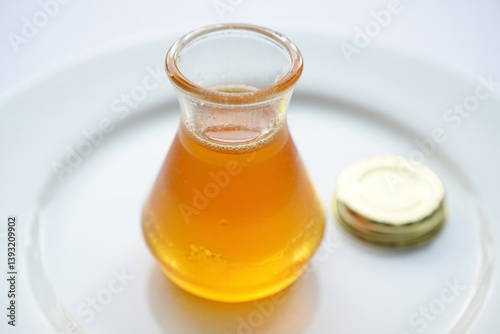 Neatly Presented Jar of Honey on a Pure White Background