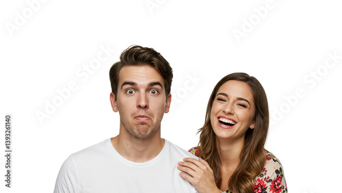 Expressive Couple: Woman laughing heartily while man makes a comically quizzical face, set against a clean background. Humorous contrast.