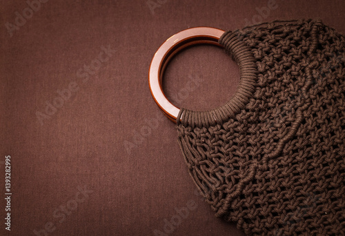 brown macrame bag on brown background, suitable for banners and advertising of macrame and boho crafts.