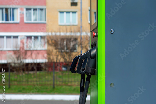 Wallpaper Mural Electric vehicle charging station with green color in an urban residential area, surrounded by apartment buildings and greenery. Torontodigital.ca