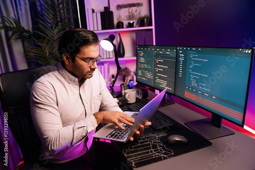 Obraz na płótnie Smart IT developer working on laptop to type searching in software coding system at neon light office room, creating application program update latest version online website database online. Surmise. w salonie