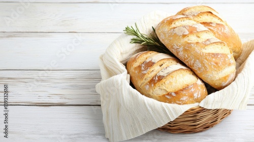 Freshly baked bread in a rustic basket on a wooden surface.