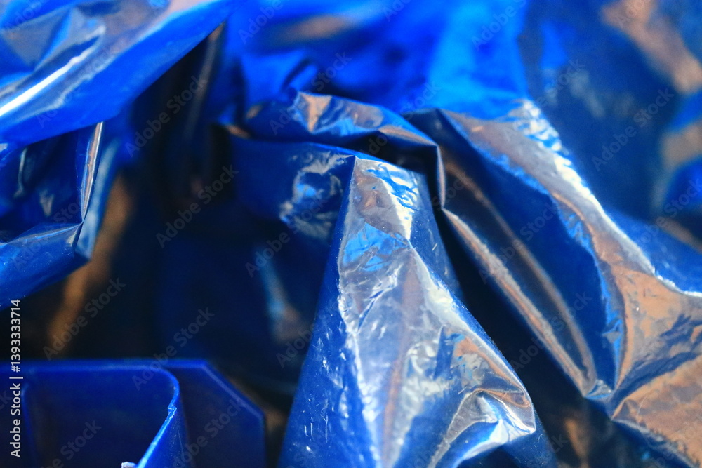 A close-up view of a blue plastic bag with creases and folds.