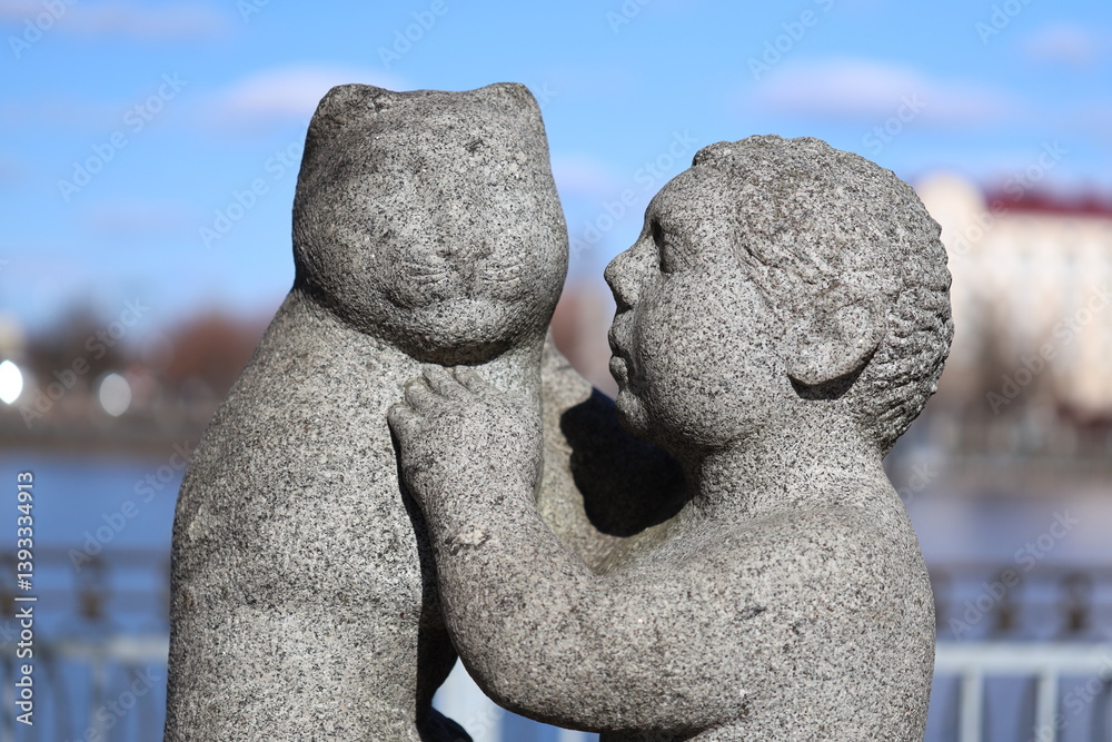 Sculpture of two kids embracing, a symbol of love and affection.