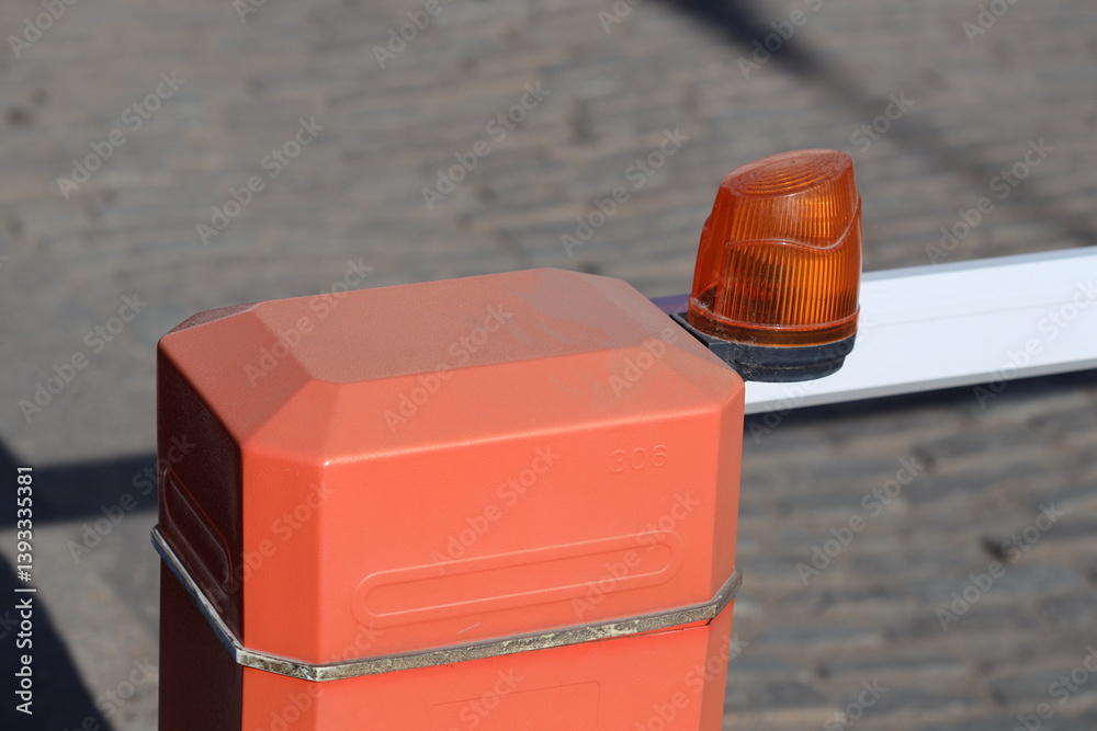 A close-up view of a traffic light on a pole, with details of the light's colors and features.