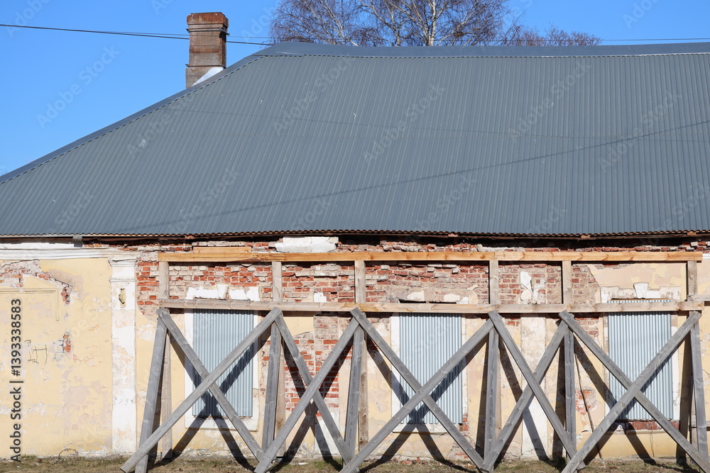 A vintage-style building with a metal roof and brick walls, suitable for use in historical or nostalgic contexts.