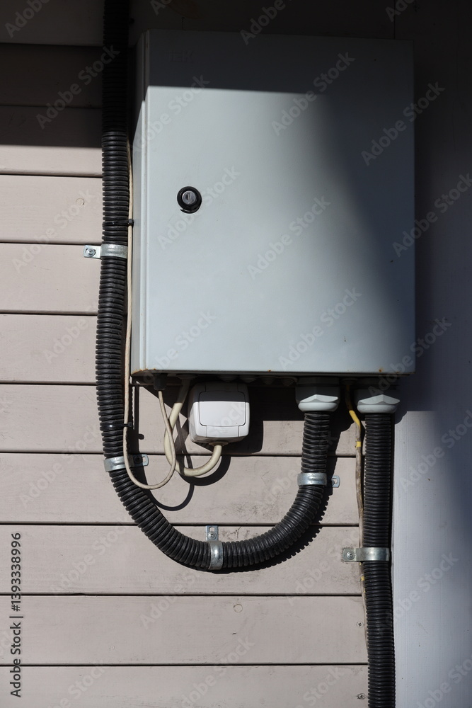 A metal box with various wires attached.