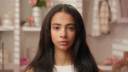 Wallpaper Mural Portrait beautiful ethnic Latina Hispanic woman teenager serious emotion girl close up face makeup routine healthy skin hair care in pink bathroom female looking at camera fashion model health medical Torontodigital.ca