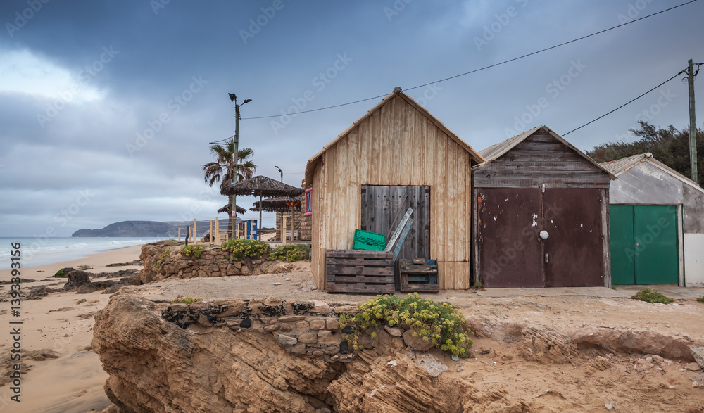 Rustic wooden huts sit serenely at the edge of cliff/ Porto Santo