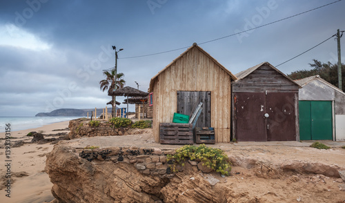 Obraz na płótnie Rustic wooden huts sit serenely at the edge of cliff/ Porto Santo w salonie