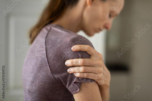 woman with pain in shoulder joint
