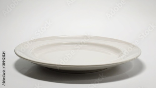 Obraz na płótnie A single white plate sits on top of a table, ready for use w salonie