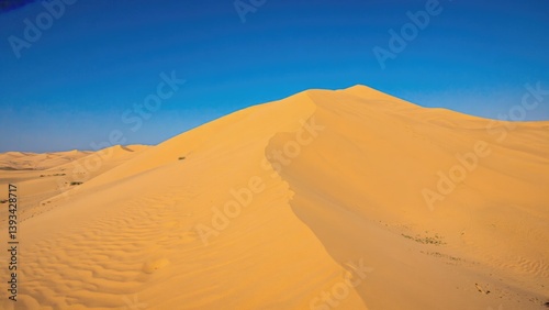 A large sand dune in a desert landscape, perfect for travel or adventure themes