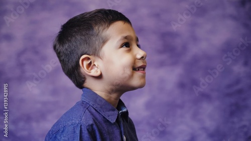 Obraz na płótnie A young boy wearing a blue shirt and tie, possibly for a formal occasion or special event w salonie