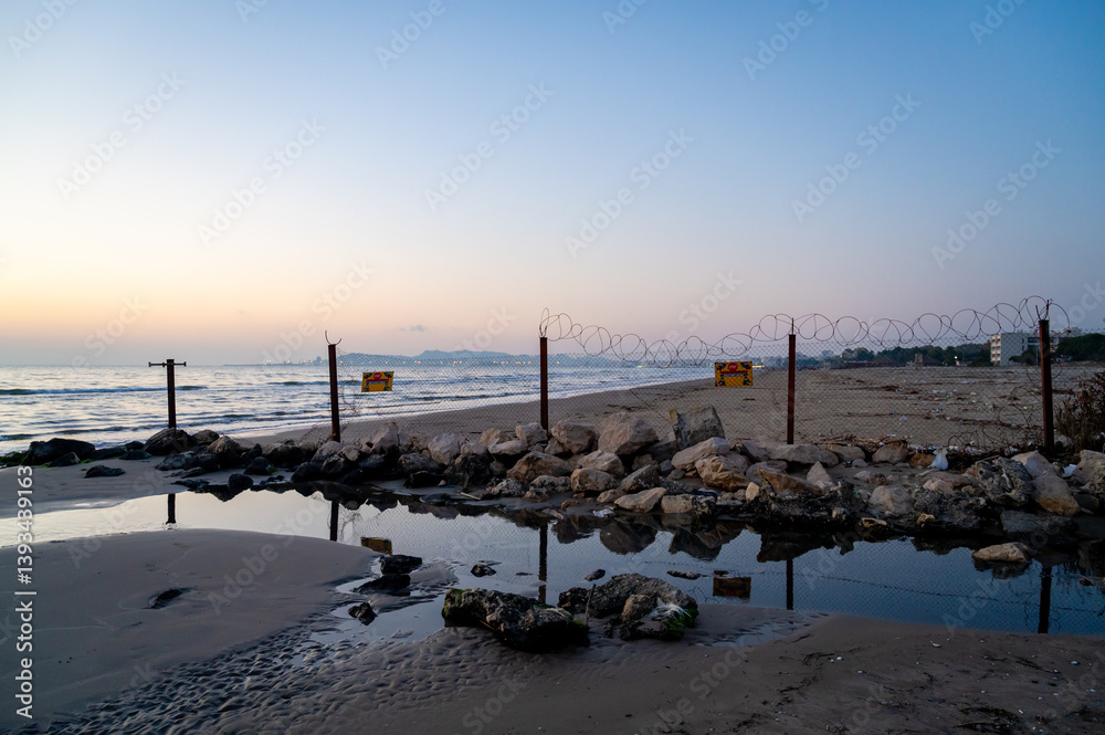Restricted Beach Area with Barbed Wire Fence – Military or Border Zone.