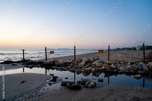 Obraz na płótnie Restricted Beach Area with Barbed Wire Fence – Military or Border Zone. w salonie