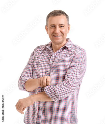 Mature man rolling up his s...
