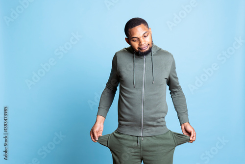 Obraz na płótnie African american broke person with empty pockets being worried about unemployment, having no money and living in poverty. Poor cashless guy deals with bankruptcy, expensive lifestyle. w salonie