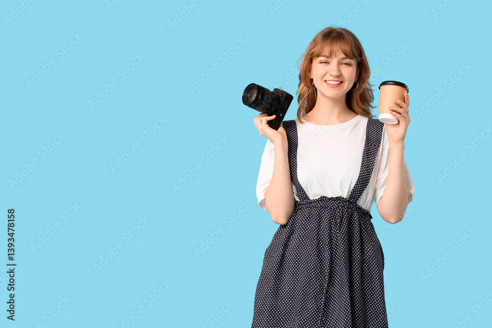 Obraz premium Beautiful young woman with modern camera and paper cup on blue background