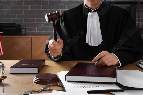 Mature judge with gavel at ...