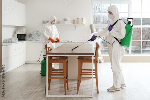 Male workers disinfecting t...