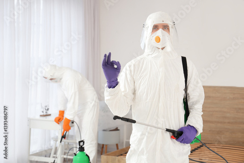 Male worker with disinfecta...