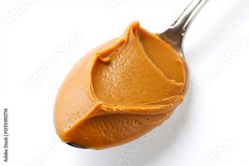 Evenly Lit Spoonful of Peanut Butter on Seamless White Surface