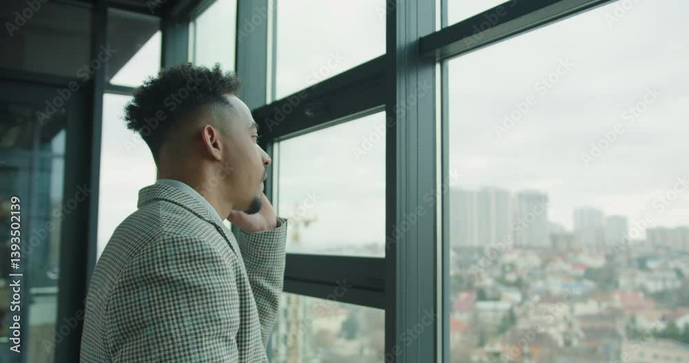 Professional businessman having a phone call near a window. Professional businessman having a phone call near a window.