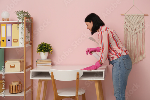 Young woman with spray bott...